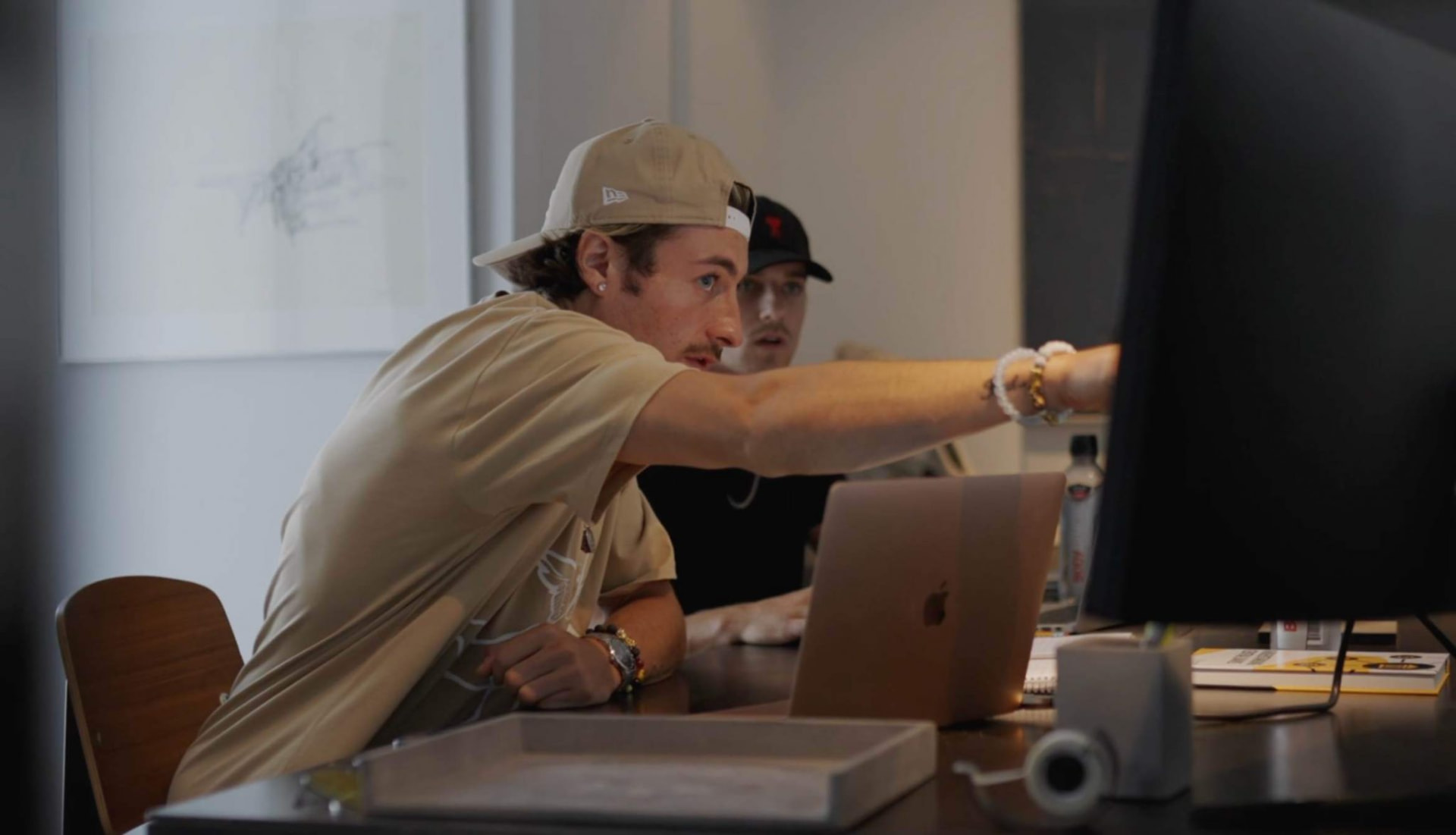 Griffin working at a desk with a laptop and monitor
